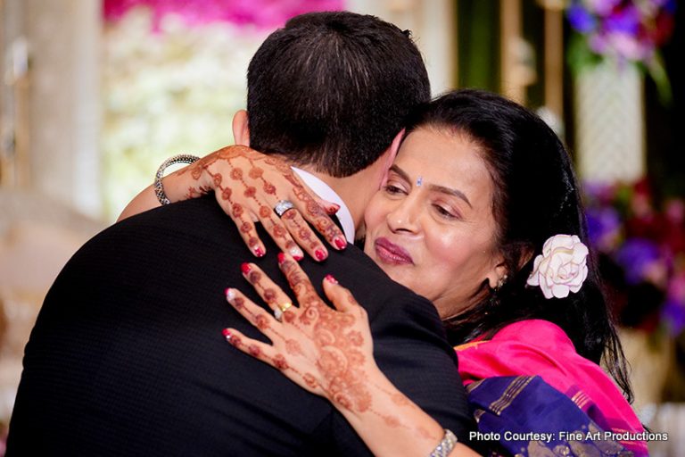 Indian groom giving a hug to his mother