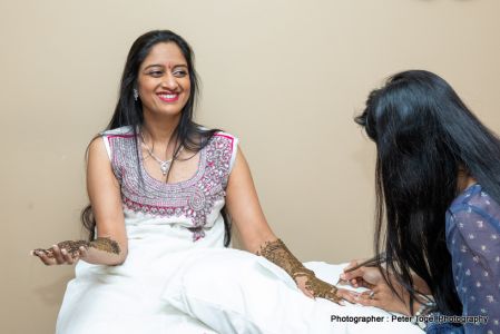 Bride applying mehndi