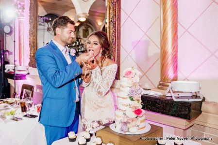 Groom feeding cake to bride