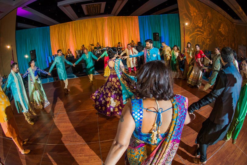 Indian Bride and Groom Dancing with Guest