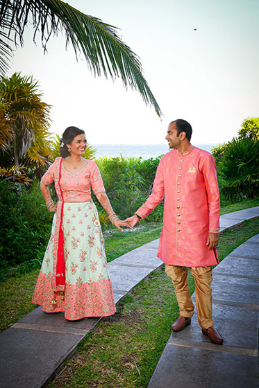 Indian bride and groom posing outdoors.