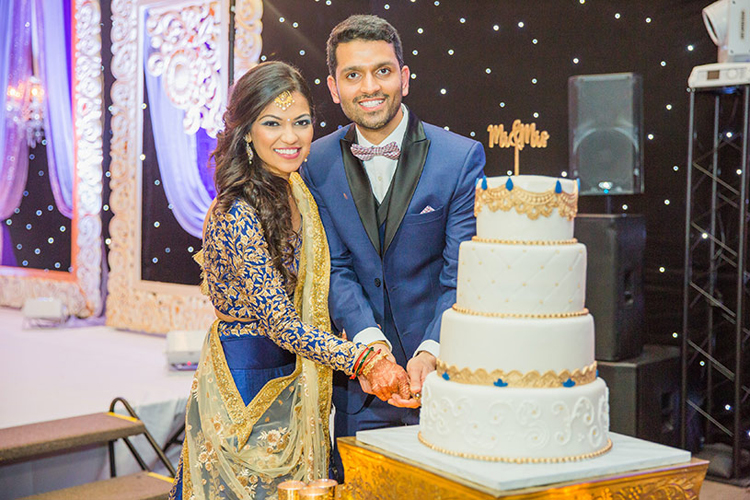 Indian Bride and Groom Cutting Cake Capture