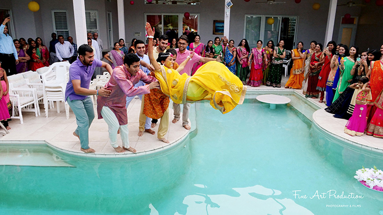 Friends Throwing the Bride in the pool after the Haldi