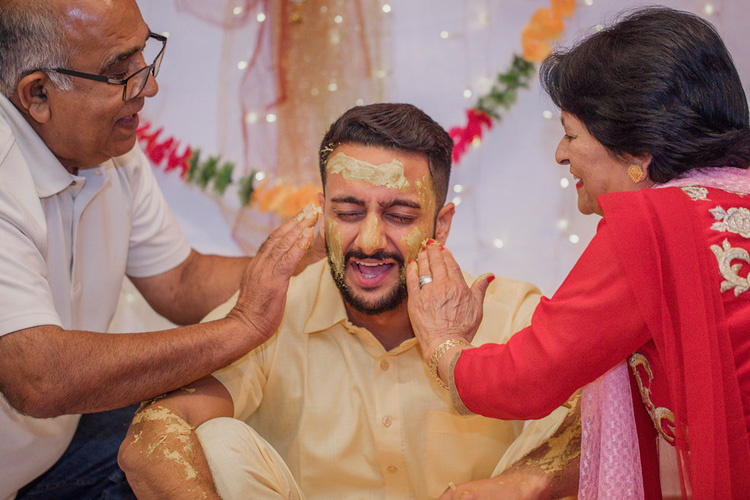 Indian Groom's Parents Applying Haldi on Indian Groom's Face