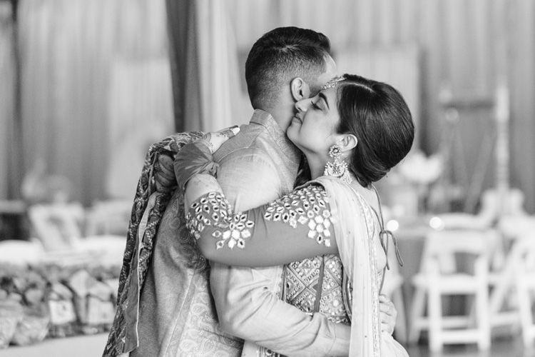 Indian bride and groom hugging to eachother
