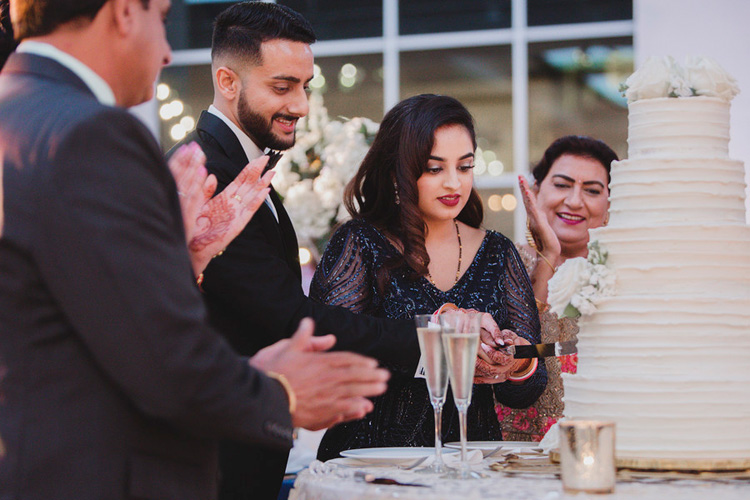 Indian Bride and Groom Cutting Their Wedding Cake