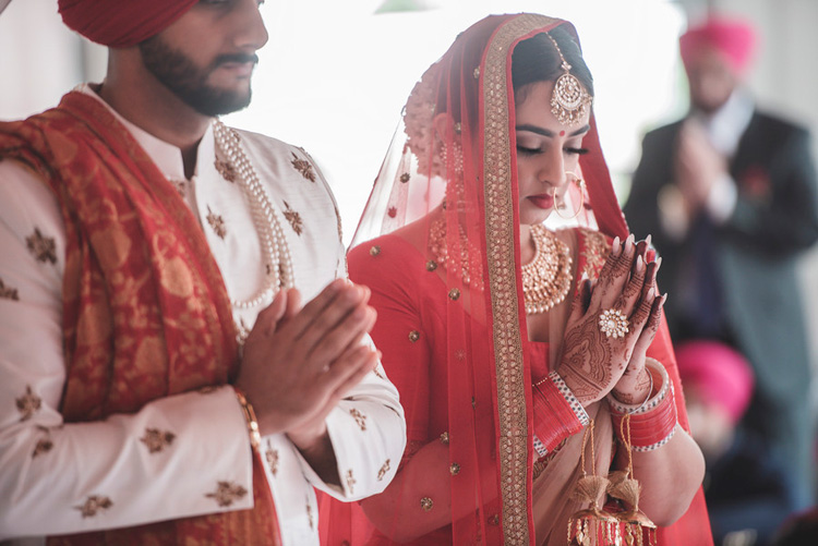 Indian Bride and Groom Taking Blessing of their Guru