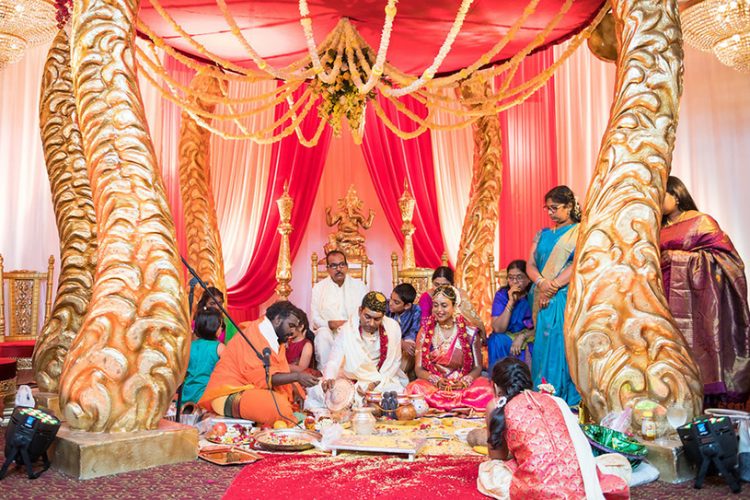 Indian Bride and Groom under Beautiful Indian Wedding Mandap