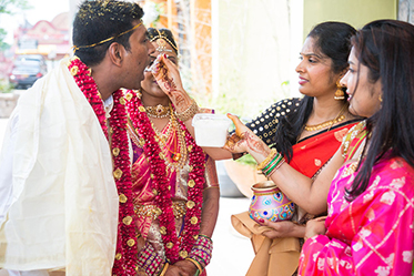 Indian Groom's Guest giving Curd to Indian Groom