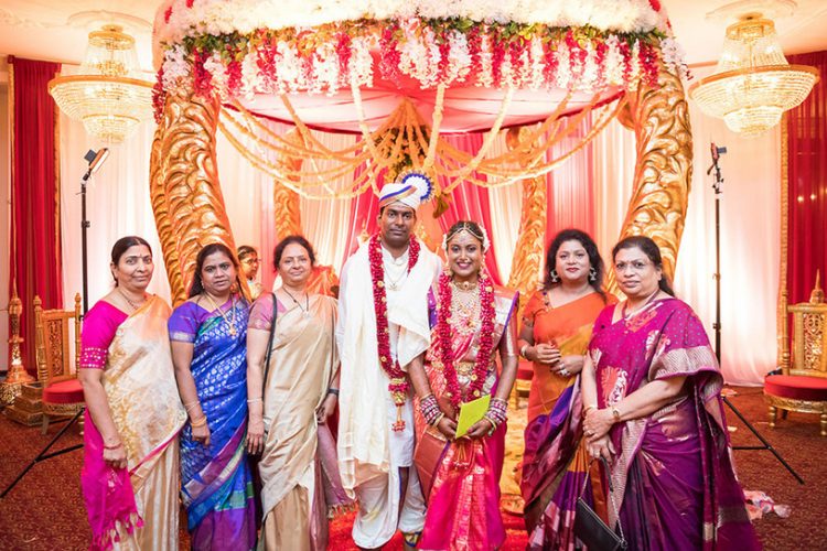 Indian Bride and Groom Possing with their Mother's Friend