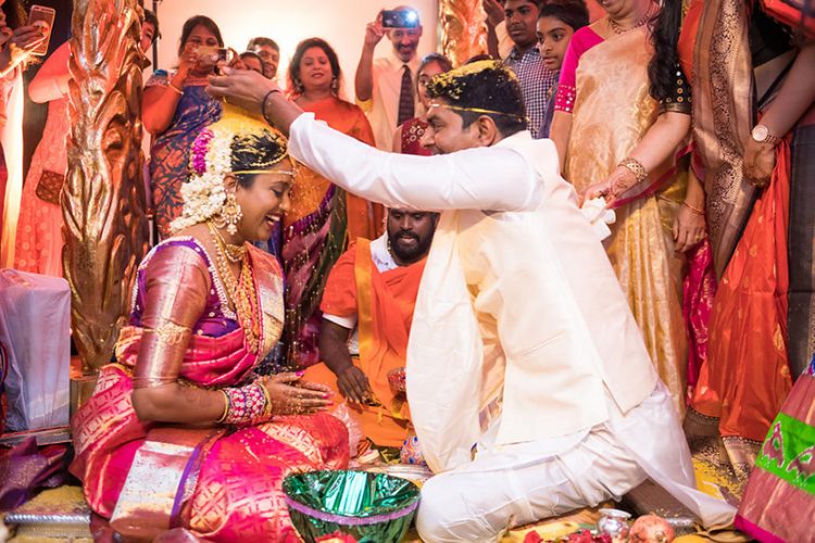 Indian Groom Putting Grains on Bride's Head