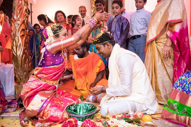 Indian Bride putting Grains on Indian Groom's Head