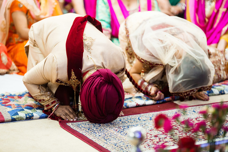 Indian Bride and Groom Bow to their Guru