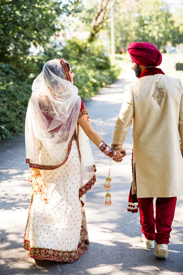 Indian Bride and Groom Walking with holding each other hands