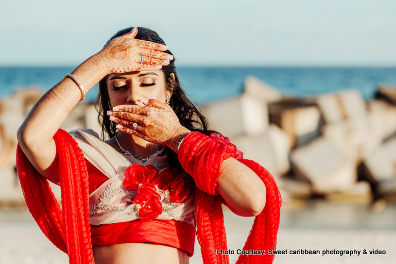 Lovely indian bride posing on the beach