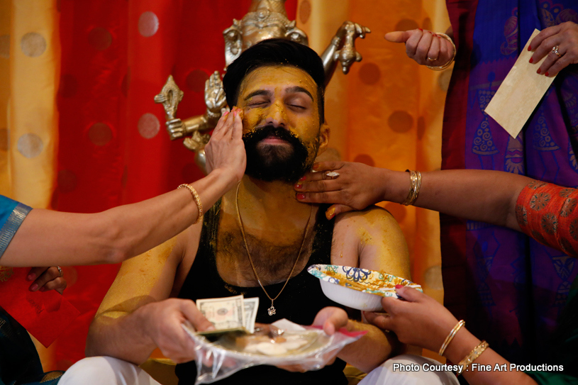 Family members Applying Haldi to indian Groom