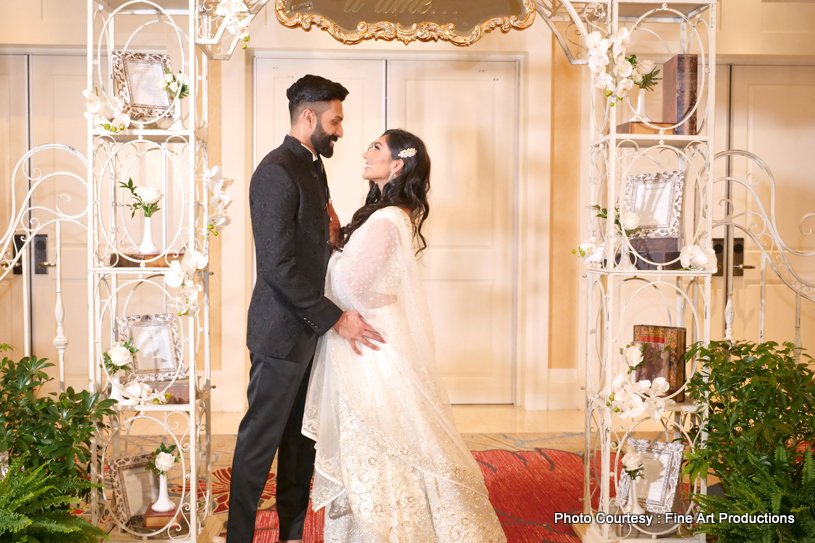 Indian bride and groom posing with their sangeet outfits