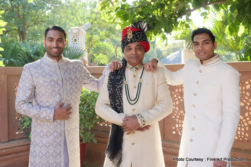 Indian groom posing with father and brother