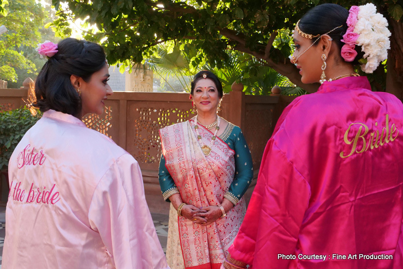 Bride posing with the sister and the mother of the bride