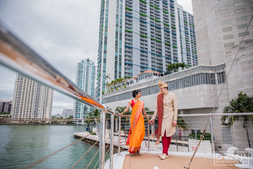 Indian Bride and Groom walking with holding eachother Hands