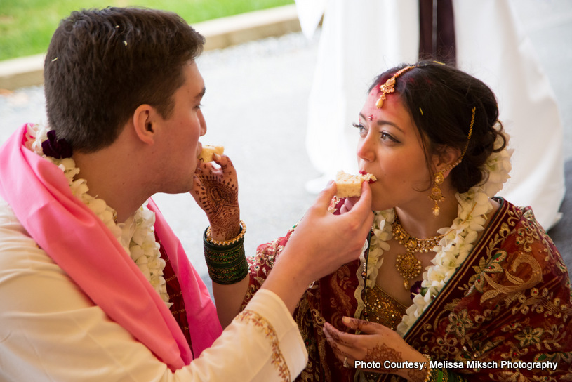 Wedding Couple feeding each other with sweet 