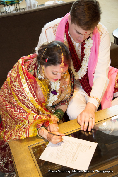Couple signing in Marriage Register Form