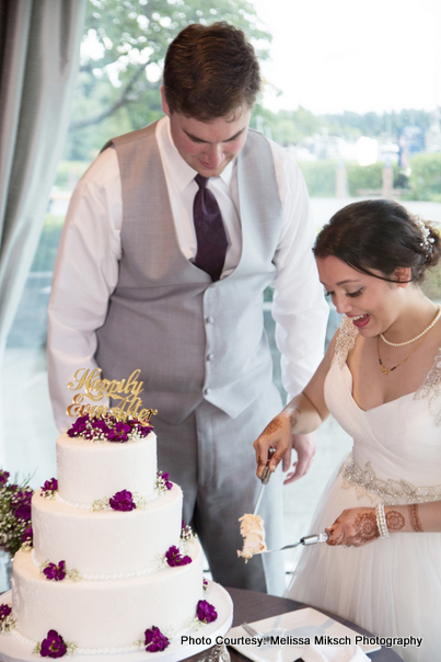 Love Birds cutting wedding cake