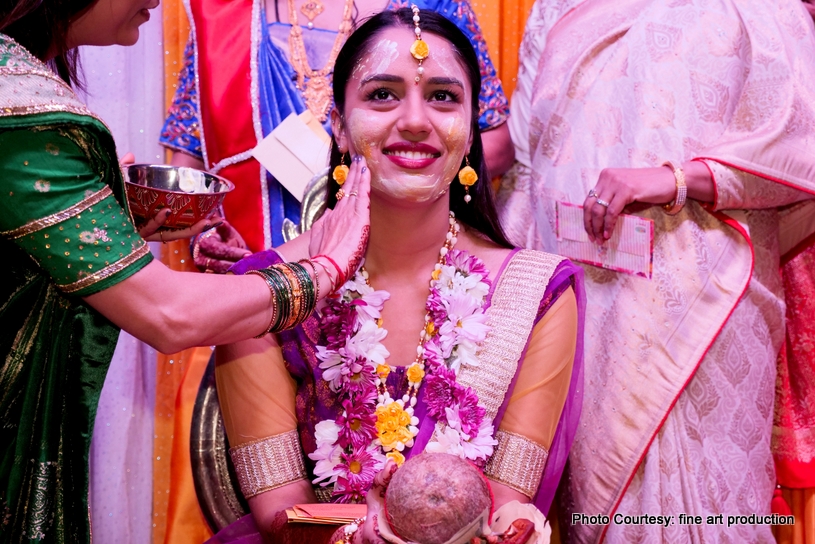 Family Members applying haldi to the bride