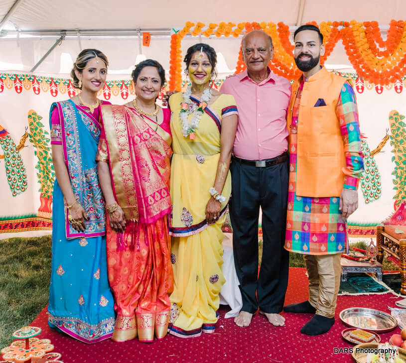Bride Posing With Family Members at Haldi Ceremony
