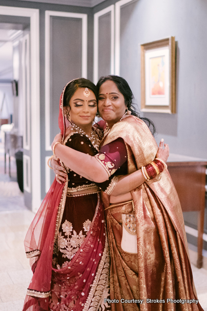 Bride giving hug to her mother 