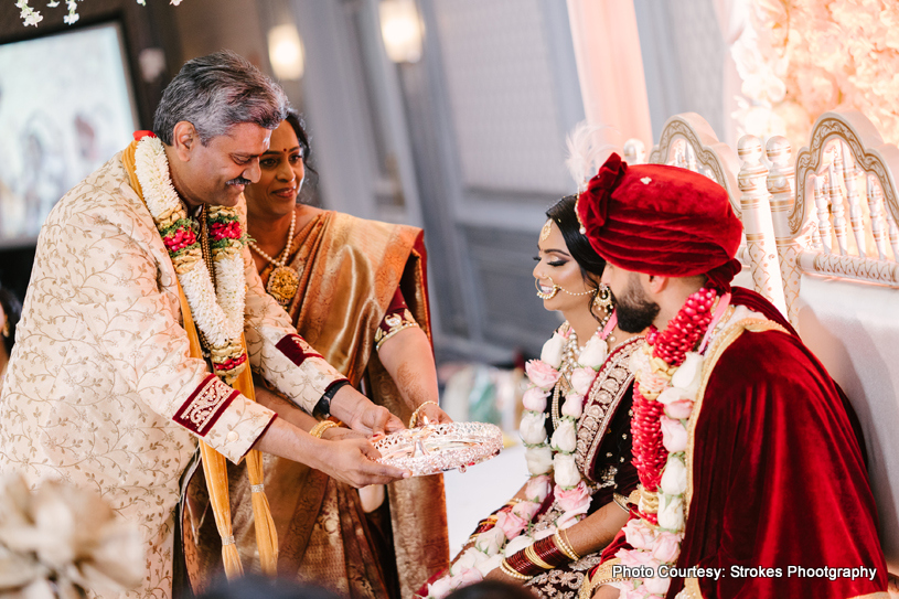 Indian grooms parents with indian couple