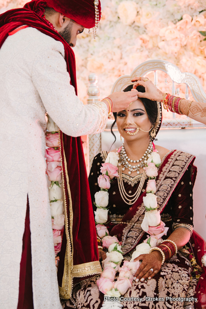 Groom applying Sindoor to Bride 