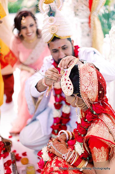 Indian Groom applying Sindoor on Bride's Forehead