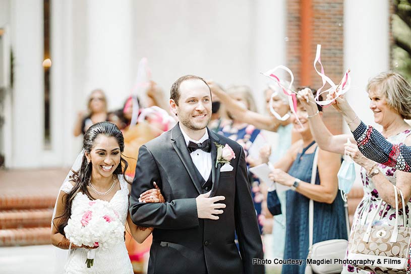 Family members applauding the entrance of Couple