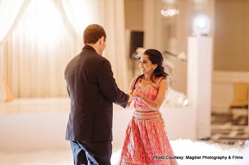 Cute Indian couple dancing at wedding 