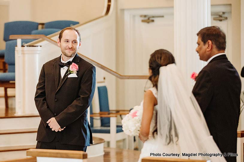 Groom looking while Indian bride entering the venue