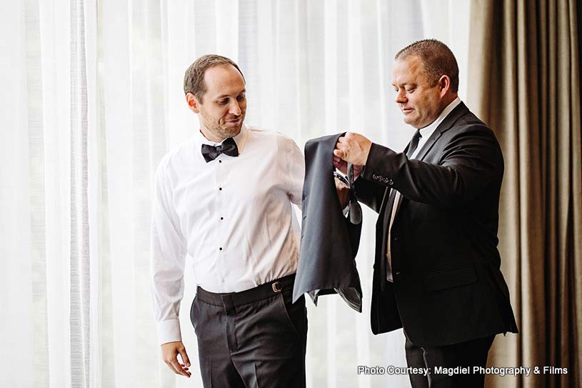 Father helping groom to get ready