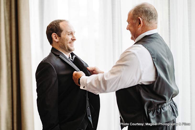 Father helping groom to get ready