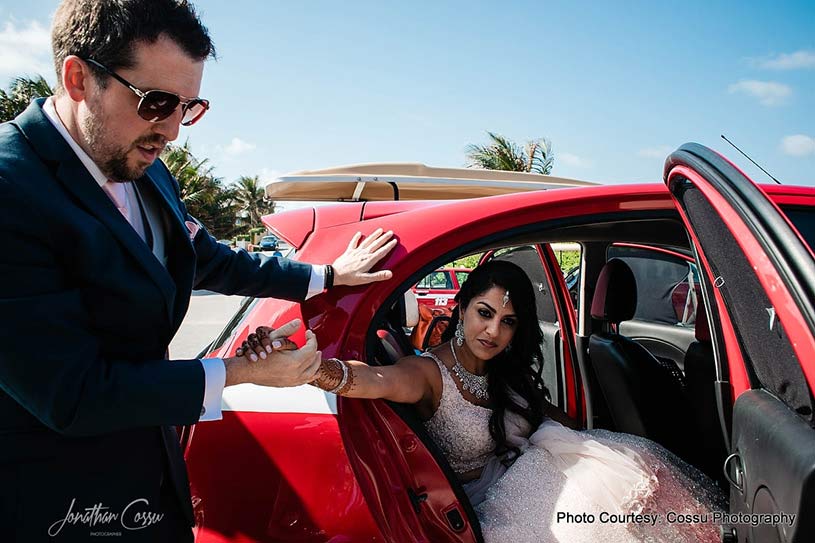 Groom taking Indian Bride out of the car