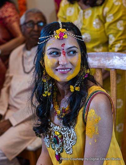 Applying termaric paste on Indian Bride's Face in Haldi Ceremony 