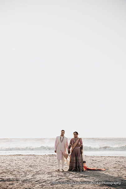 Indian bride and groom on sea shore 