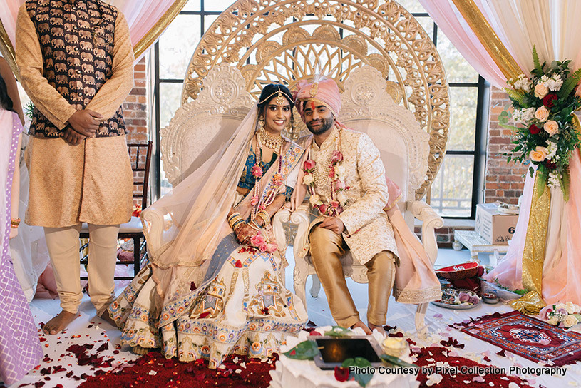 Indian bride and groom under wedding mandap