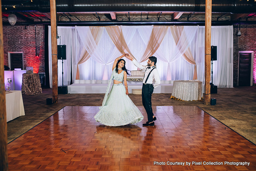 Indian newly weds couple dancing on dance floor