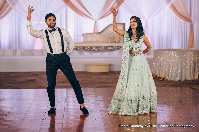 Indian bride and groom dancing at their receprion