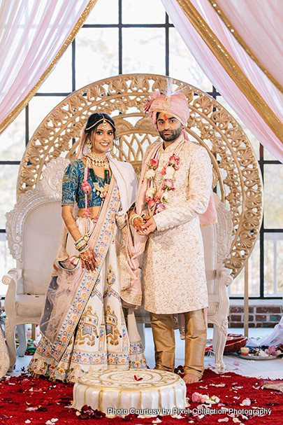 indian groom puts ring on bride's finger