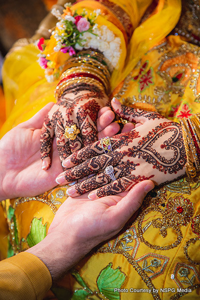 Indian wedding couple holding each others hands