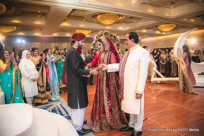 Indian wedding couple holding hands