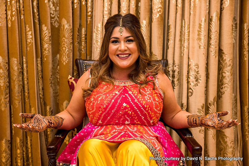 Indian bride showing her mehandi design 