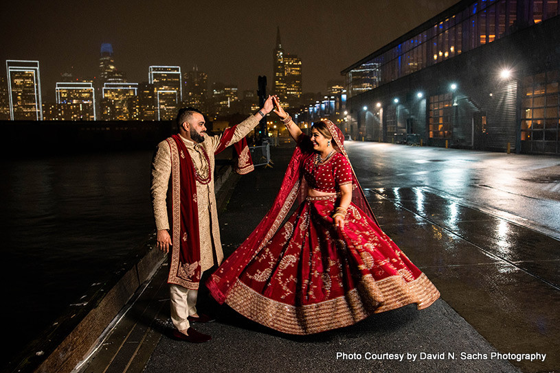 Indian bride twirling with Indian groom