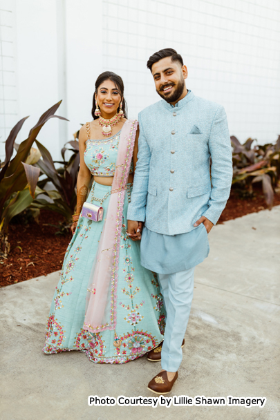 Indian wedding couple holding each others hands